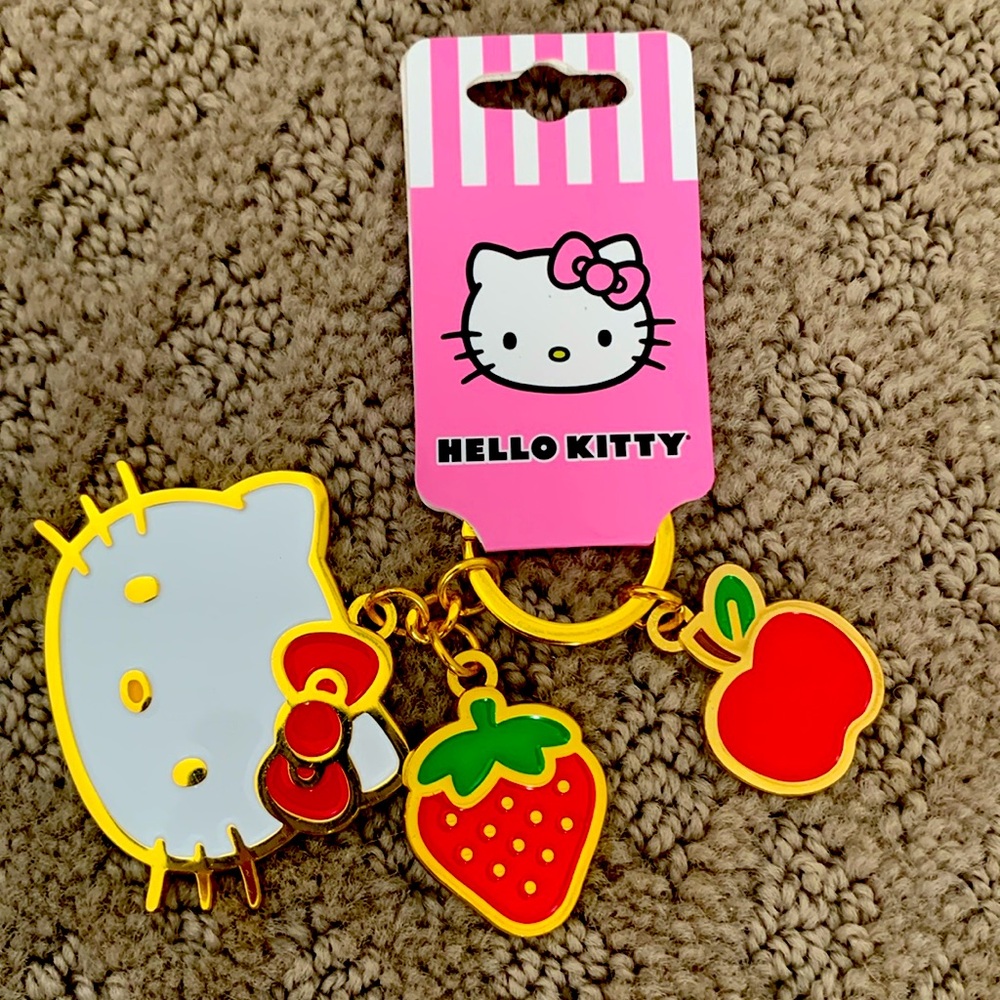 Hello Kitty gold keychain with fruits on it
